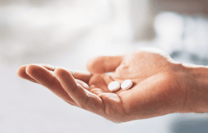 A hand holding weight-loss medications