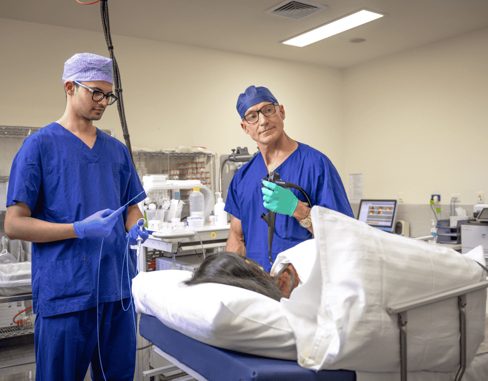 Two weight-loss surgeons conversing with a patient