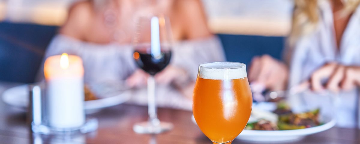 Two friends drinking alcohol at a restaurant