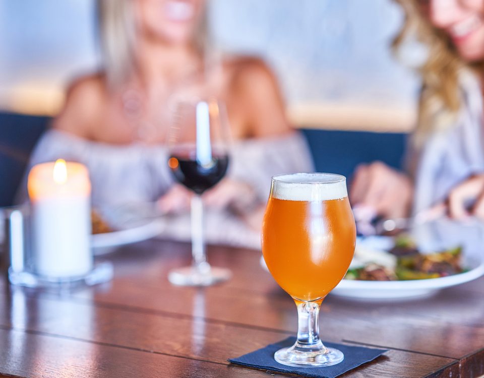 Two friends drinking alcohol at a restaurant
