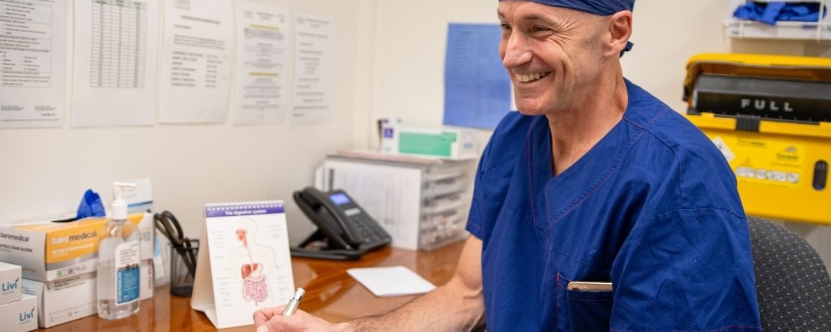 Bariatric surgeon writing a referral letter